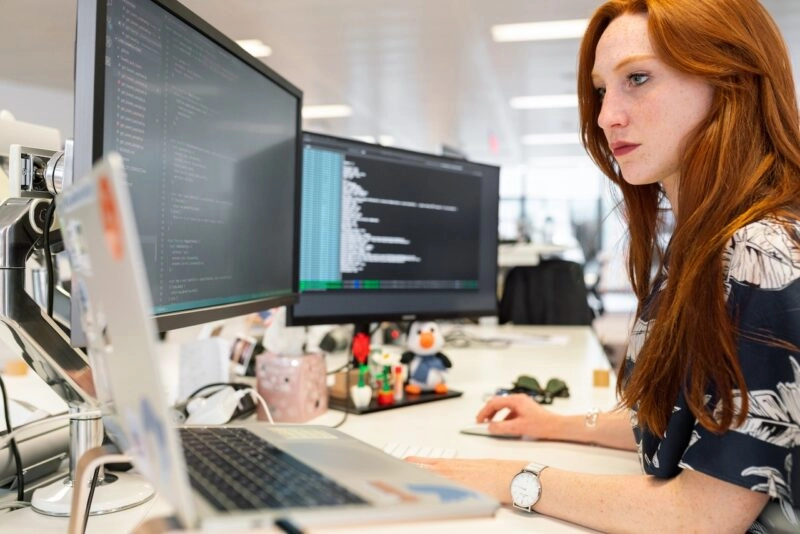Woman in tech - coding on her computer