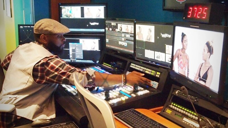 Broadcast operator reaches across the switcher